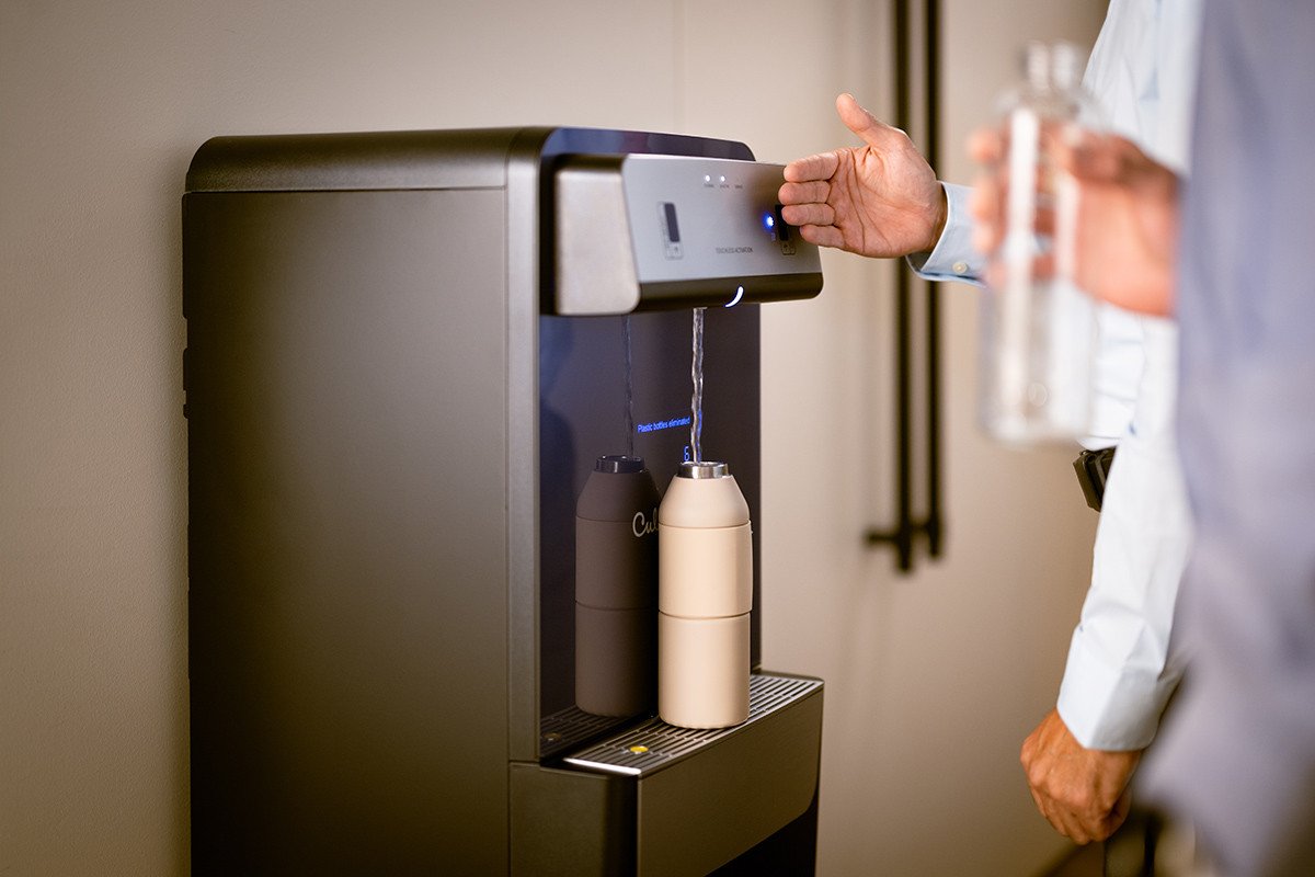 Touch-free bottleless cooler filling a water bottle